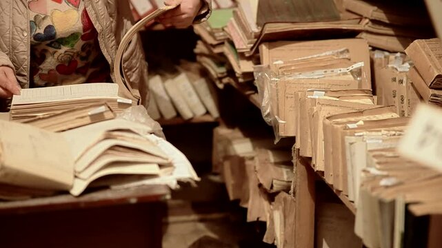 Woman Searching Through Folders in Old Archive. Document Storage Room