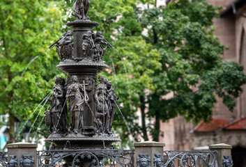 Nuremberg, Germany, August 2, 2023. On a rainy day view of the fountain of virtues. Blurred background. Travel destinations.
