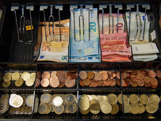 tiroir caisse d'un commerce en France avec des billets et des pièces d'euros