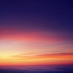 Fototapeta premium Vibrant sunset hues over a vast expanse of clouds