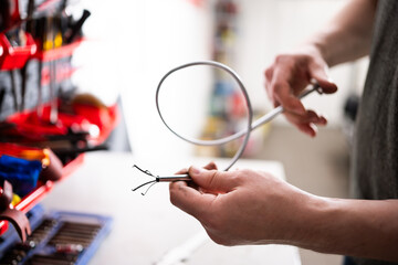 Auto Mechanic Holding In Flexible Claw Pickup Tool
