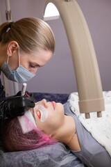 Caucasian woman undergoing eyelash lamination procedure. 