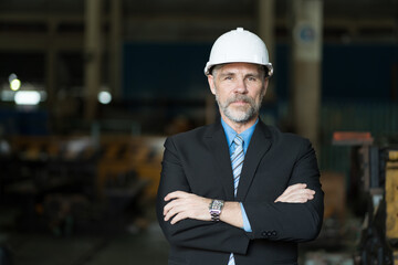 Businessman, factory or storage warehouse. Senior businessman in industry factory, inspection of machine for manufacturing, controlling factory operation