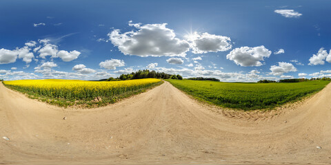 hdri 360 panorama on gravel road near rapeseed fields in equirectangular full seamless spherical...