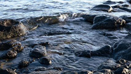 Glistening waves of the Bosphorus catch the warm colors of a sunset