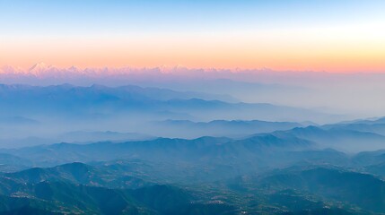 Obraz premium Serene Mountain Landscape at Dawn with Layers of Mist and Fog