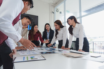 Business team analyzing data and discussing strategy in modern office