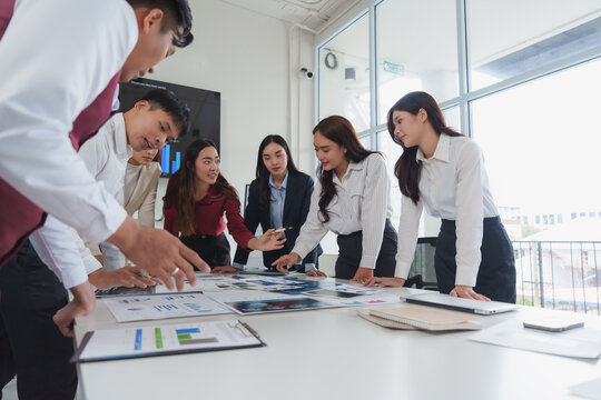 Business team analyzing data and discussing strategy in modern office