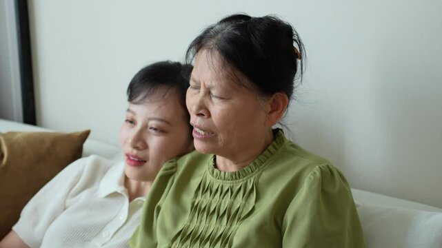 Young Asian woman talking with her mother at home