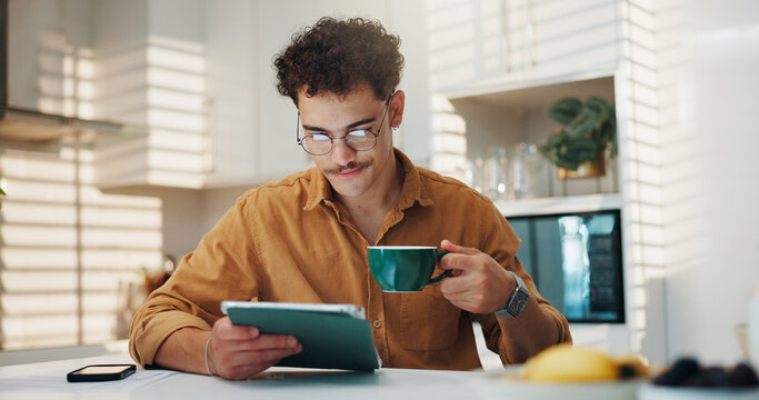 Home, coffee and man with tablet, online reading and email notification with morning news. Apartment, tech and person in kitchen, connection and herbal tea with social media, chatting and research