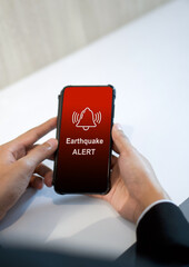 Earthquake alert warning displayed on smartphone screen as symbol, telling people to be careful....