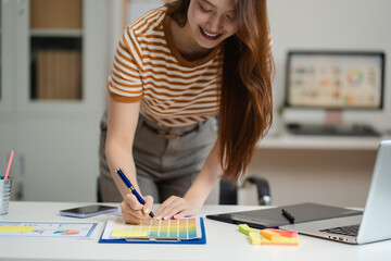 Designer woman thinking ideas strategy about mobile app interface wireframe design with customer...