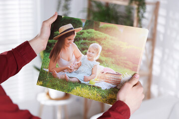 Canvas print. Woman with photo at home, closeup