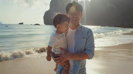 happy asian dad with little son walking along seashore in summer - Powered by Adobe