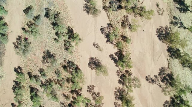 Aerial view looking down on the dry Todd River in the full sun. Alice Springs, Mparntwe, Northern Territory, Australia. August 2022.