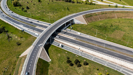 Close-up aerial image of multi-level overpass with cars in motion, highlighting complex road engineering and infrastructure