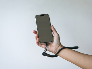 Hand Holding Phone with Wrist Strap. Isolated on white background.