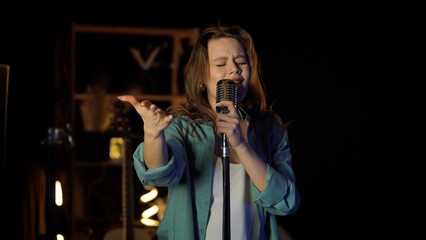 Young Woman Performing Energetically with Microphone on Stage