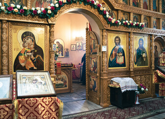 Wooden altar iconostasis, Easter flower decoration. Interior of a temple in Severny, Belgorod region in Russia.