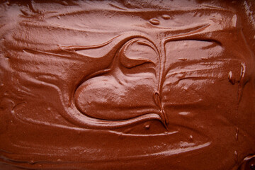 Close Up Top View of Handmade Melted Chocolate Brownie Mixture Background with word love, food background, Chocolate Spread Typography