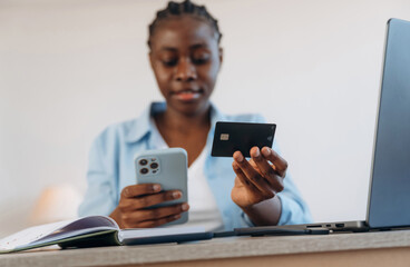 Credit card, online payment. Woman is at home in domestic room
