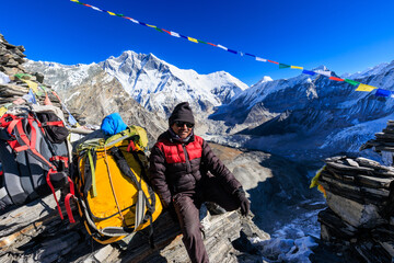 Sherpa guide resting after reaching amphu labsta pass (5,845m) in the Honku Valley in the Himalaya...