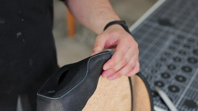 Steering wheel upholstery in imitation leather. A fragment of a dark polyurethane material.