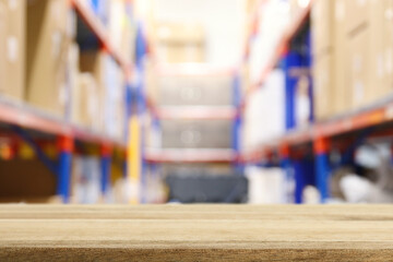 Empty table and industry warehouse background with bright lights