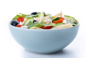 Mediterranean Pasta Salad in bowl with Fresh Vegetables and Herbs isolated on white background