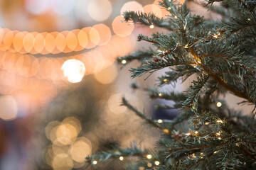 New Year's card 2026. Festive garlands and lights on the Christmas tree. Close-up. Beautiful...