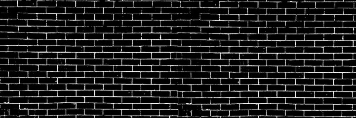 A black and white grungy brick wall. Dilapidated brick pattern in black and white. Black brick wall background.