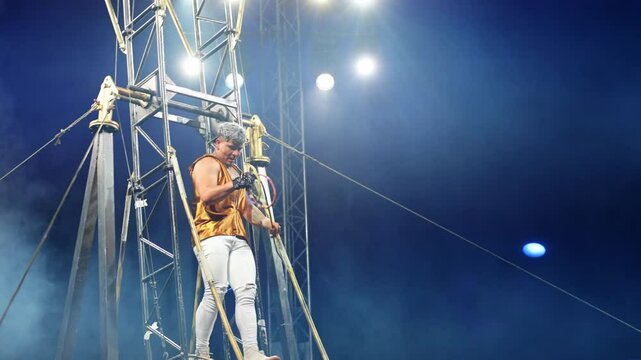 Brave male acrobats in the rotating wheel of death perform under the dome of the circus.