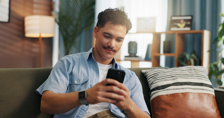 Plakat Relax, smile and man with mobile on sofa for communication, chat and reading message. Home, online and happy person with smartphone for texting, social media and browsing website to download app