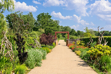 Wide gravel alleyway through the gardens of RHS Bridgewater park.