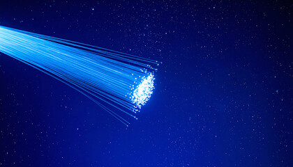 Abstract image showcasing fiber optics against a cosmic blue backdrop. Ideal for illustrating concepts like connectivity, data transfer, technology or future. Evokes speed, innovation.