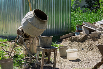 Concrete mixer close-up during renovation or construction on a farm