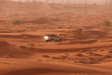 Off-Road Vehicle in Red Sand Dunes of the Desert