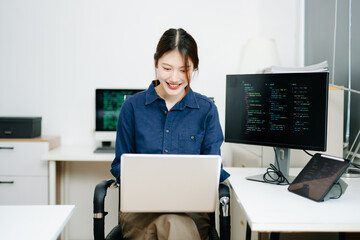 Young female programmer working with tablet and screen displaying code. Modern tech office setup, great for software, coding, IT