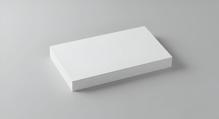 Clean, minimalist stack of white business cards on a neutral background. Ideal for showcasing print design or advertising.