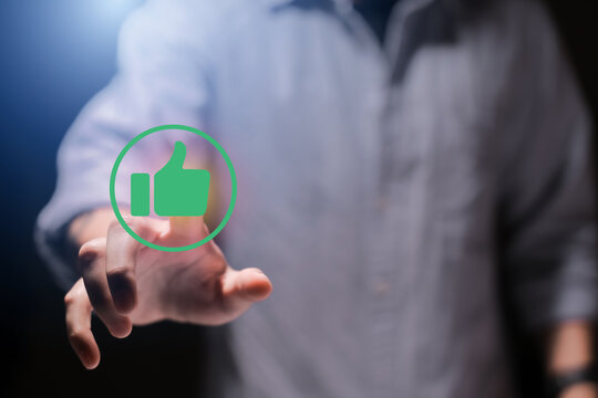 Man using smartphone or tablet, pointing finger at like button, thumbs down button, Interface,Thumbs up icon, display screen, touch screen, Virtual Image Technology