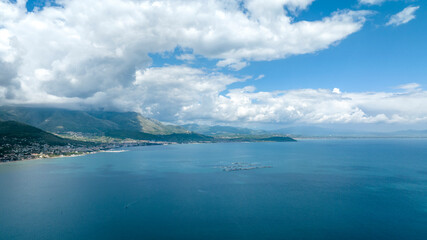 Aerial view of mountains of the Lazio coast in the province of Latina, Italy. The mountains overlook the Mediterranean Sea on a cloudy day.