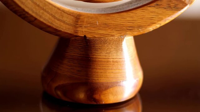 Detailed wooden celtic pattern showing textured wood grain with interwoven and repeating knot shapes and a smooth carved surface