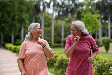 Indian happy senior women jogging in the park.