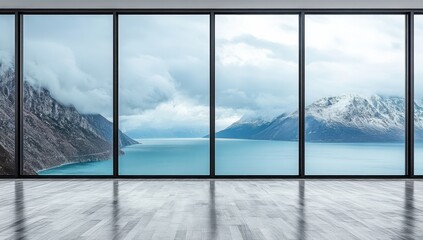 Empty room with large windows overlooking a mountain lake