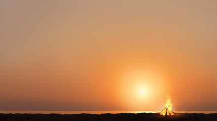 Sunset Over Calm Sea with Flickering Campfire on Sandy Beach Offering Tranquil Atmosphere for Evening Gatherings and Reflection