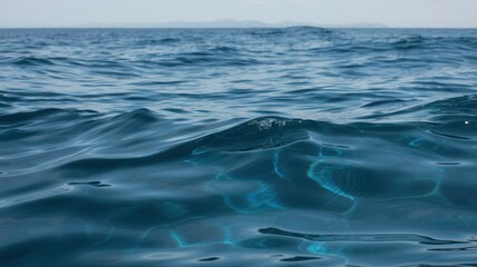 Fototapeta premium Real Deep Blue Sea Texture, Ocean Surface Detail, Natural Water Waves, Rich Blue Tones, Sunlight Reflection on Water, Marine Environment, Calm Sea, Water Ripples, Coastal Texture, Deep Ocean View