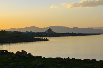 Beautiful landscape with lake and building. Sunset over the sea. Beautiful architecture on the seashore