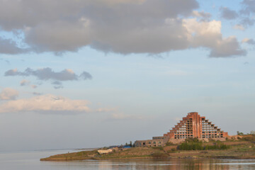 Fototapeta premium Beautiful landscape with lake and building. Sunset over the sea. Beautiful architecture on the seashore