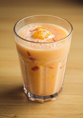 Peach Mango Smoothie in Glass on Wooden Table