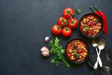 Chili con carne - traditional mexican minced meat and vegetables stew in tomato sauce. Top view with copy space.